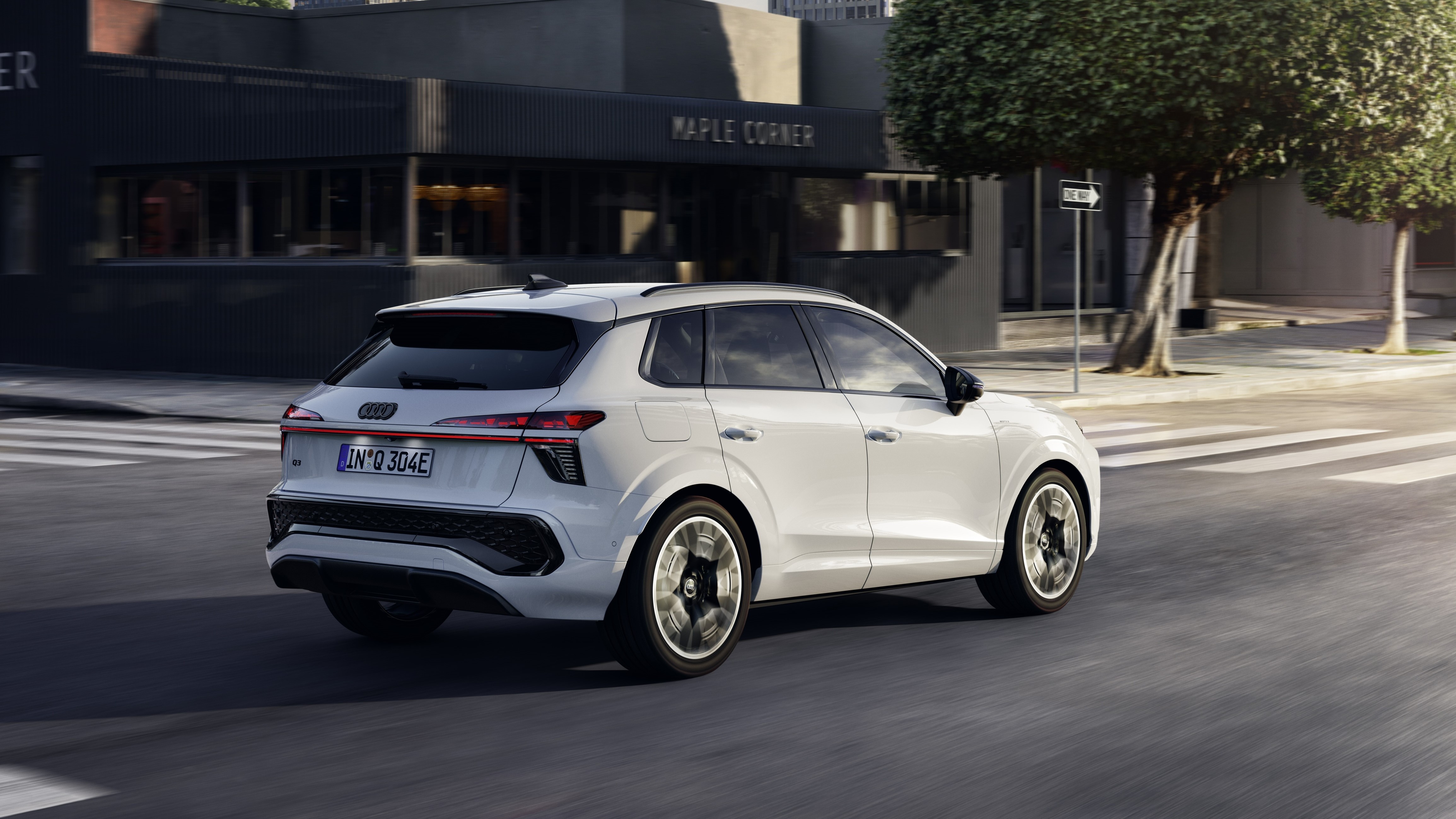 Audi Q3 e-hybrid rijdend door de stad, achteraanzicht